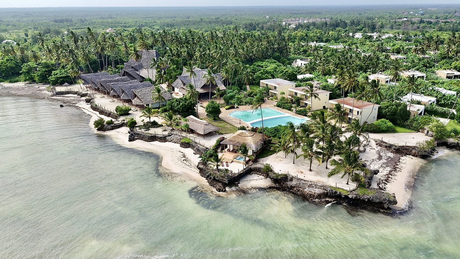 Aerial view of the turquoise lagoon and reef at Uroa Beach