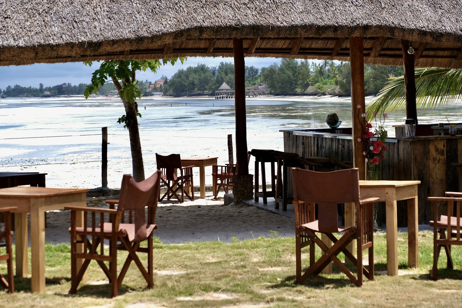 Beachfront dining pavilion on the white sand at Uroa